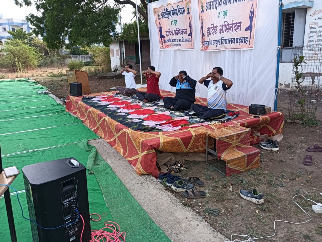 Participants performing yoga during Vikas Khand level International Yoga Day program at Sandipani Vidyalaya Barwah